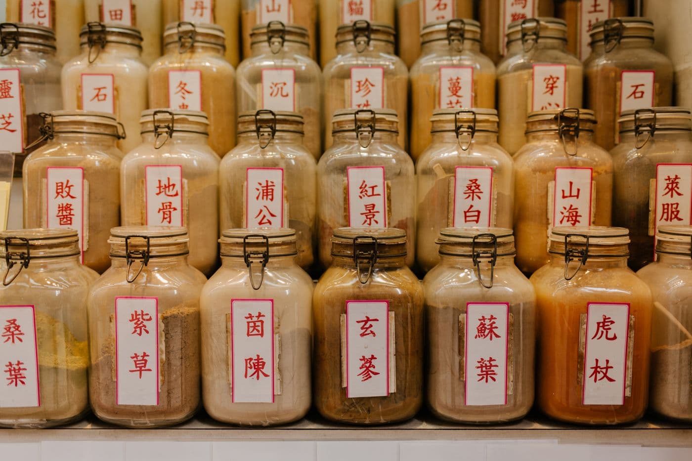 Herbal medicine jars with Chinese labels in a traditional shop